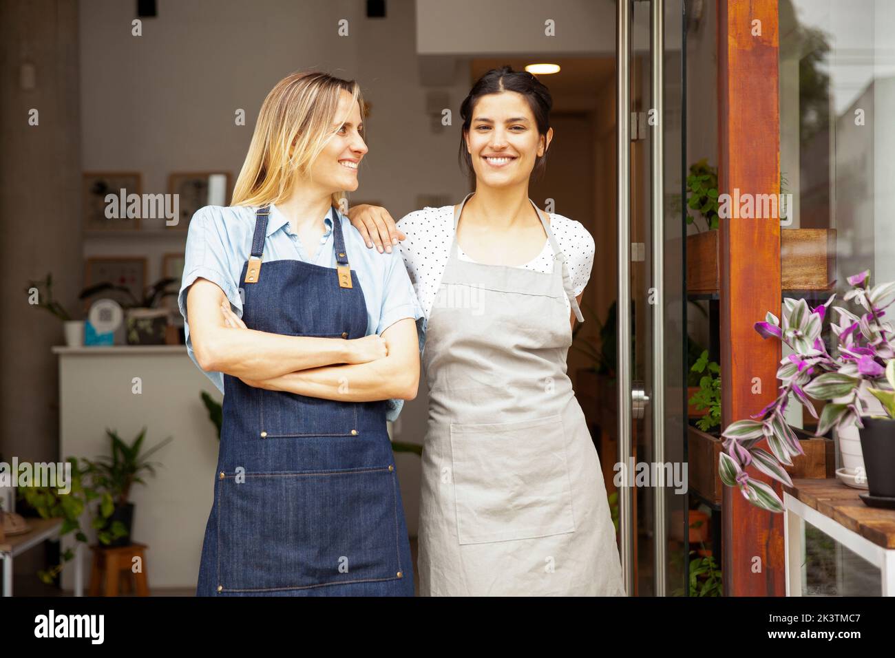 Small business flower shop owners standing with arms crossed Stock Photo