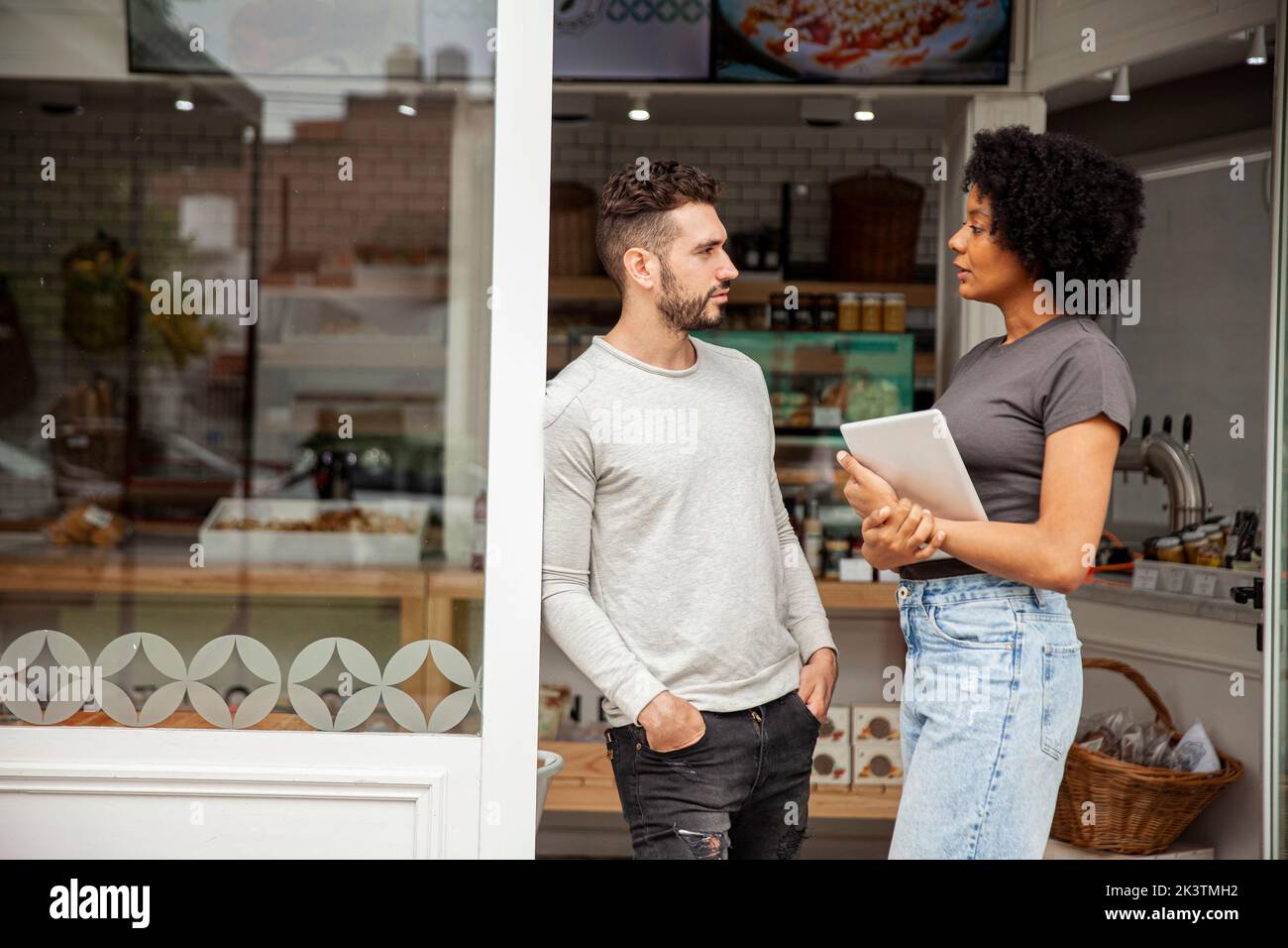African American bakery owner standing with colleague Stock Photo