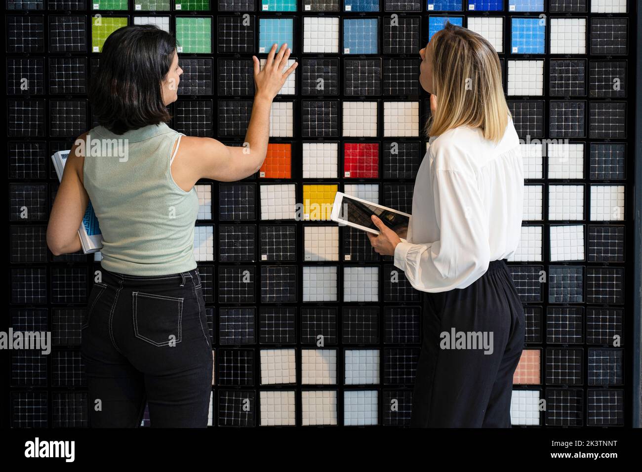Two female home decorators choosing patterns in their studio Stock Photo