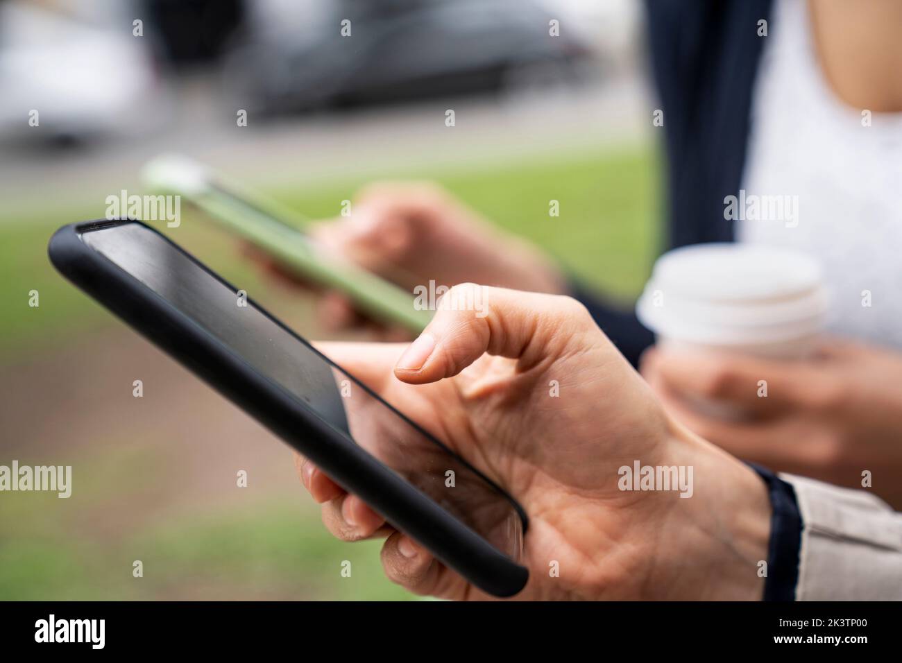 Close-up shot of two women's hands holding smartphones Stock Photo