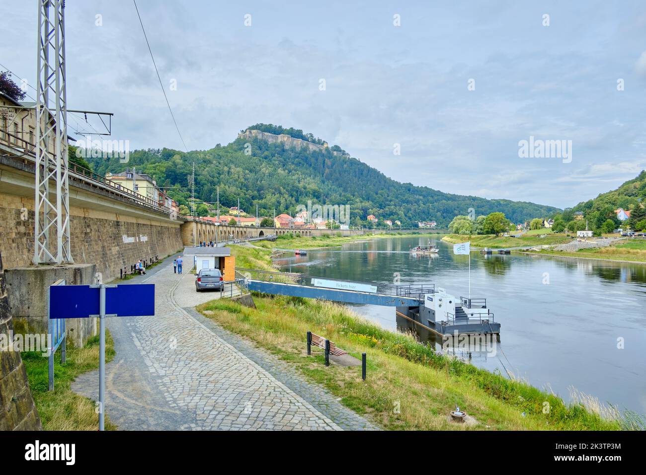 Königstein, Saxony, Germany, August 7, 2019: Idyllic Elbe river scenery and ferry in Saxon Switzerland as well as the famous Königstein Fortress. Stock Photo