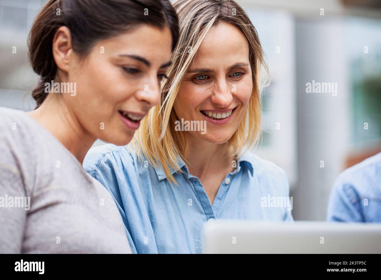 Small business coworkers sitting outdoor using laptop Stock Photo
