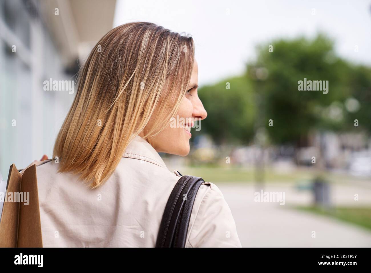 Mid-shot sideview of woman's face walking in the street Stock Photo