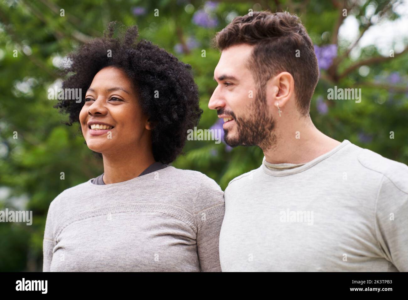 Mid-shot portrait of an African-American woman and Caucasian man having a good time outdoors Stock Photo