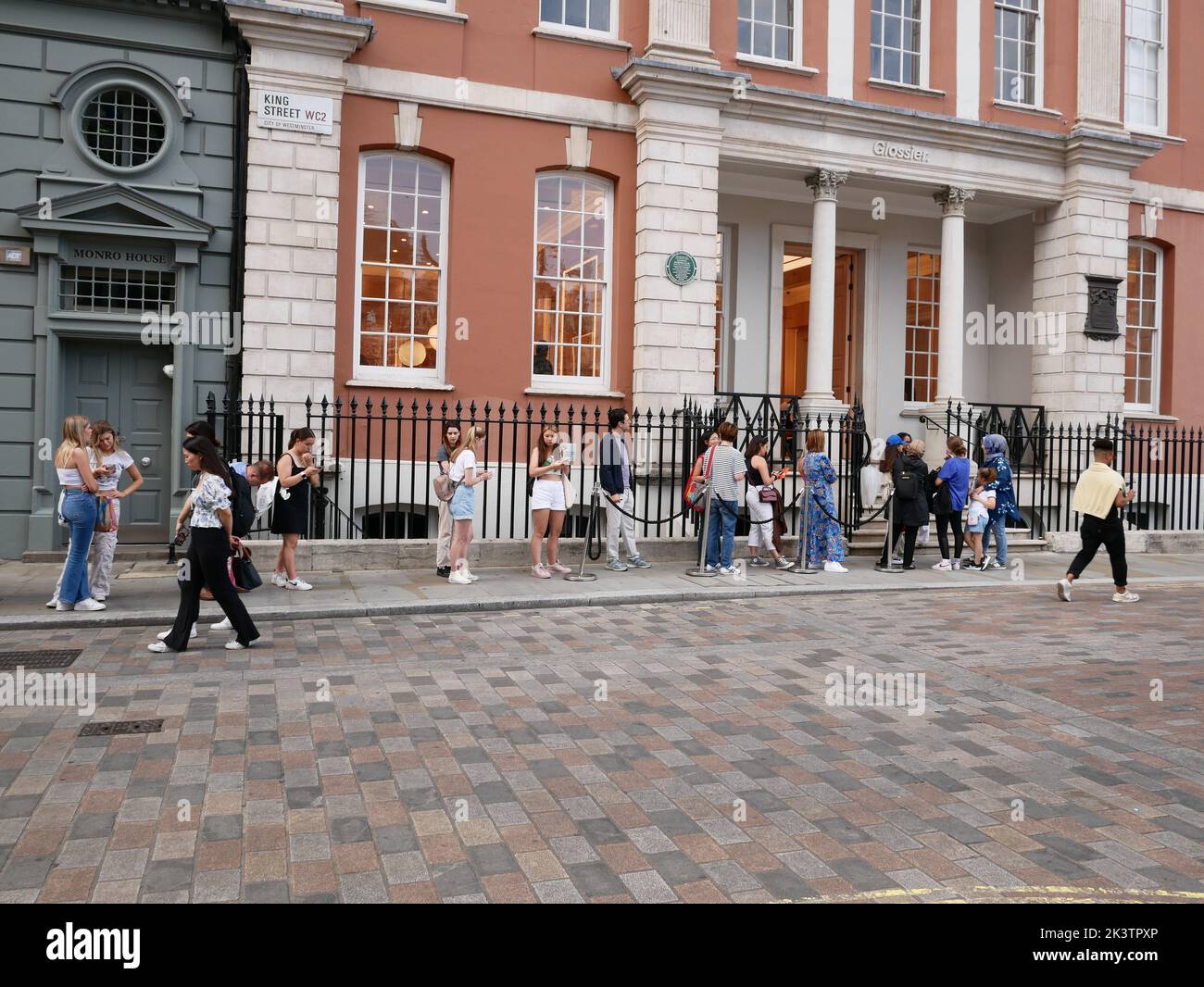 Customers queue in line to visit Glossier store, Covent Garden, London, England UK Stock Photo