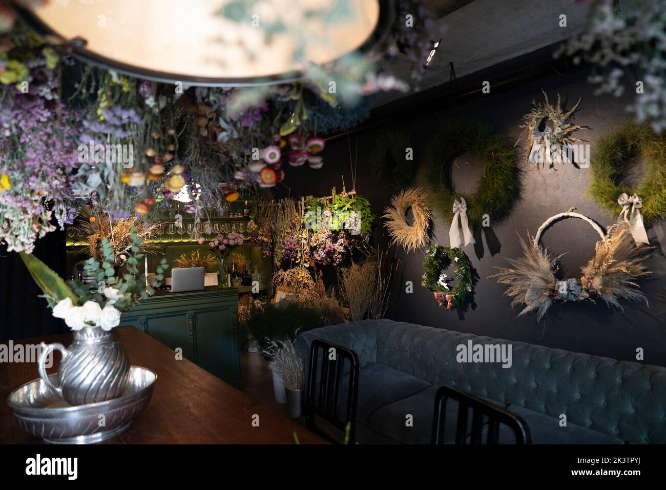 A collection of dry flower bouquets and wreaths displayed on wall of wine-bar Stock Photo