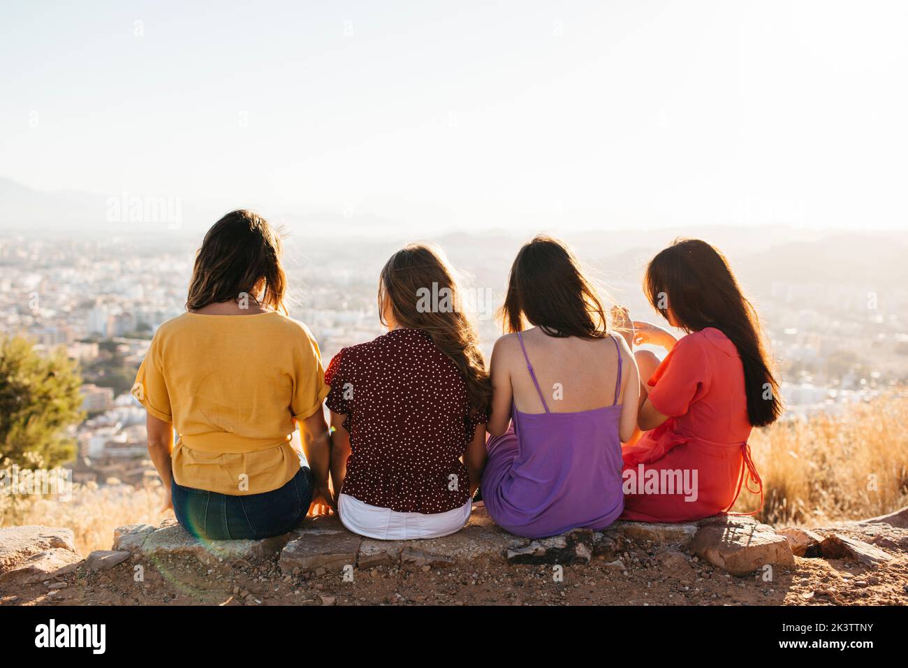 Back view of group of anonymous young female friends in casual outfits ...