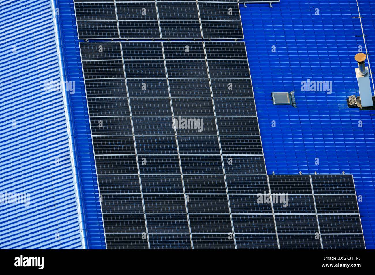 Aerial top down photo of solar panels PV modules mounted on flat roof photovoltaic solar panels