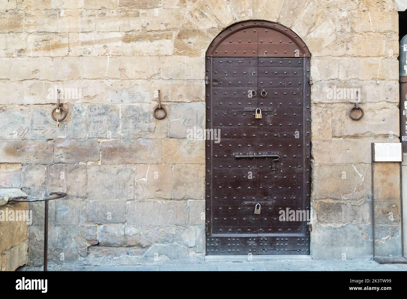 FLORENCE, ITALY - SEPTEMBER 18, 2018: This is a fortified door and hitching posts on the wall of a medieval house on the Old Bridge (Ponte Vecchio). Stock Photo