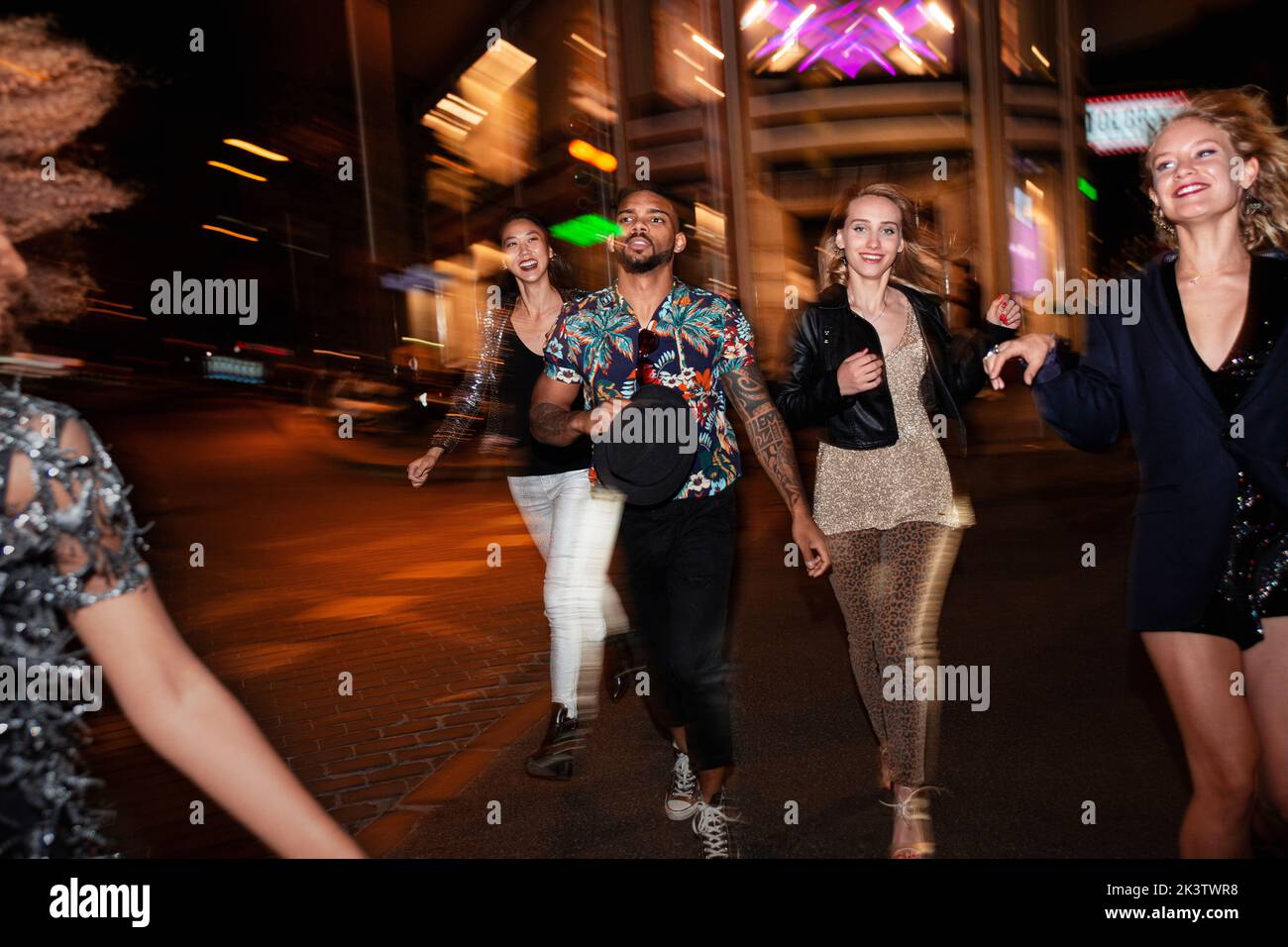 Group of stylish multiracial friends walking together on city street ...