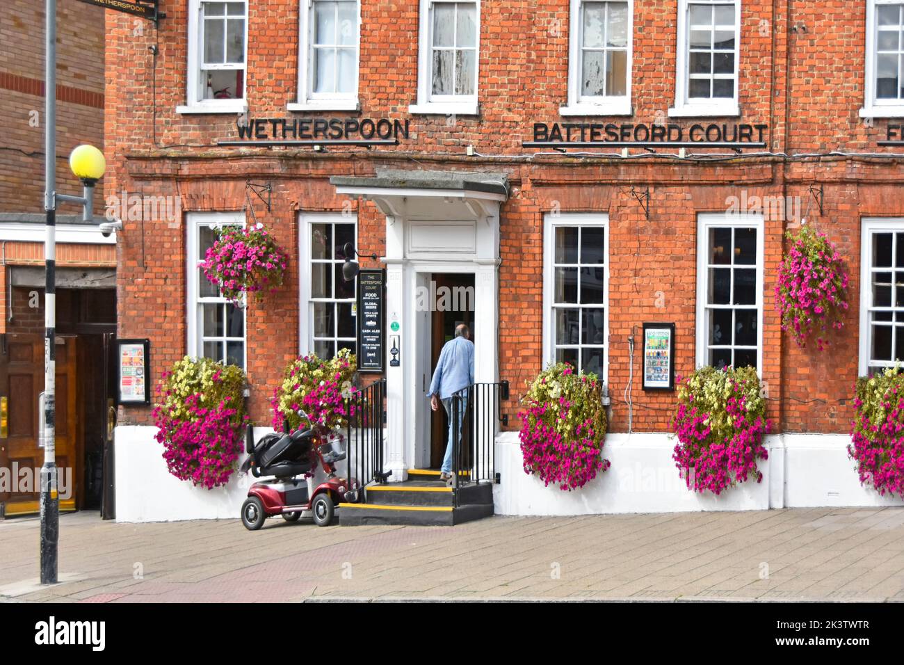 Battesford Court historical 16th-century building now Weatherspoon pub and restaurant decorated outside with colourful summer flowers Witham Essex UK Stock Photo