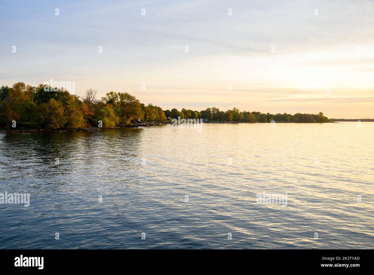 Wooded shores of a lake at sunet. Tranquil scene. Stock Photo