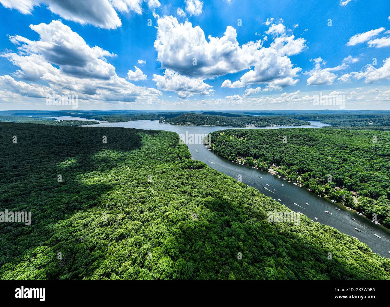 An aerial view of a river flowing through the rainforests under a ...