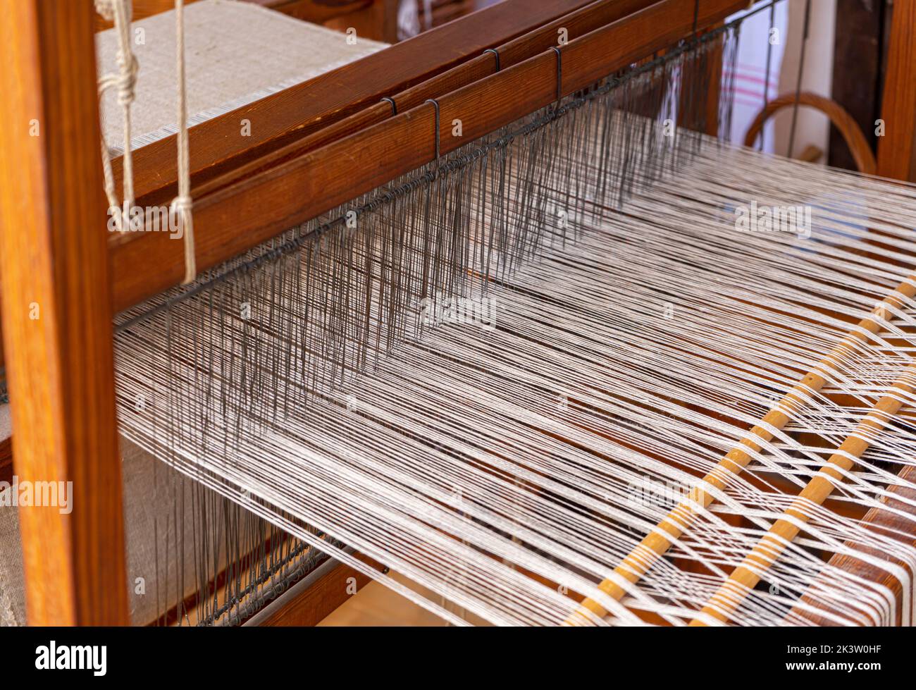 Closeup shot of a historic wooden loom with threads Stock Photo