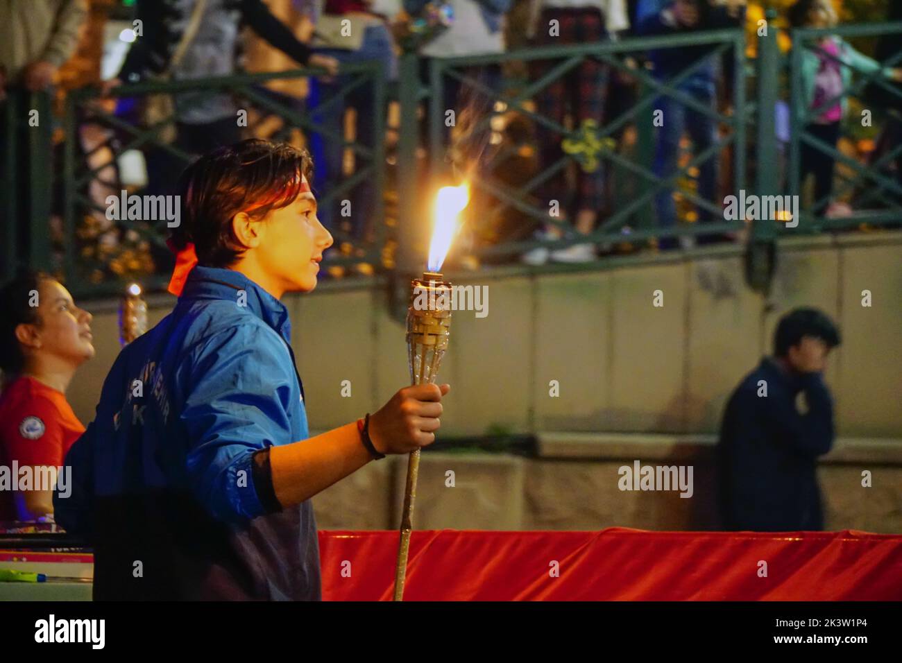 A young boy holding a fire torch symbolizing the independence of the