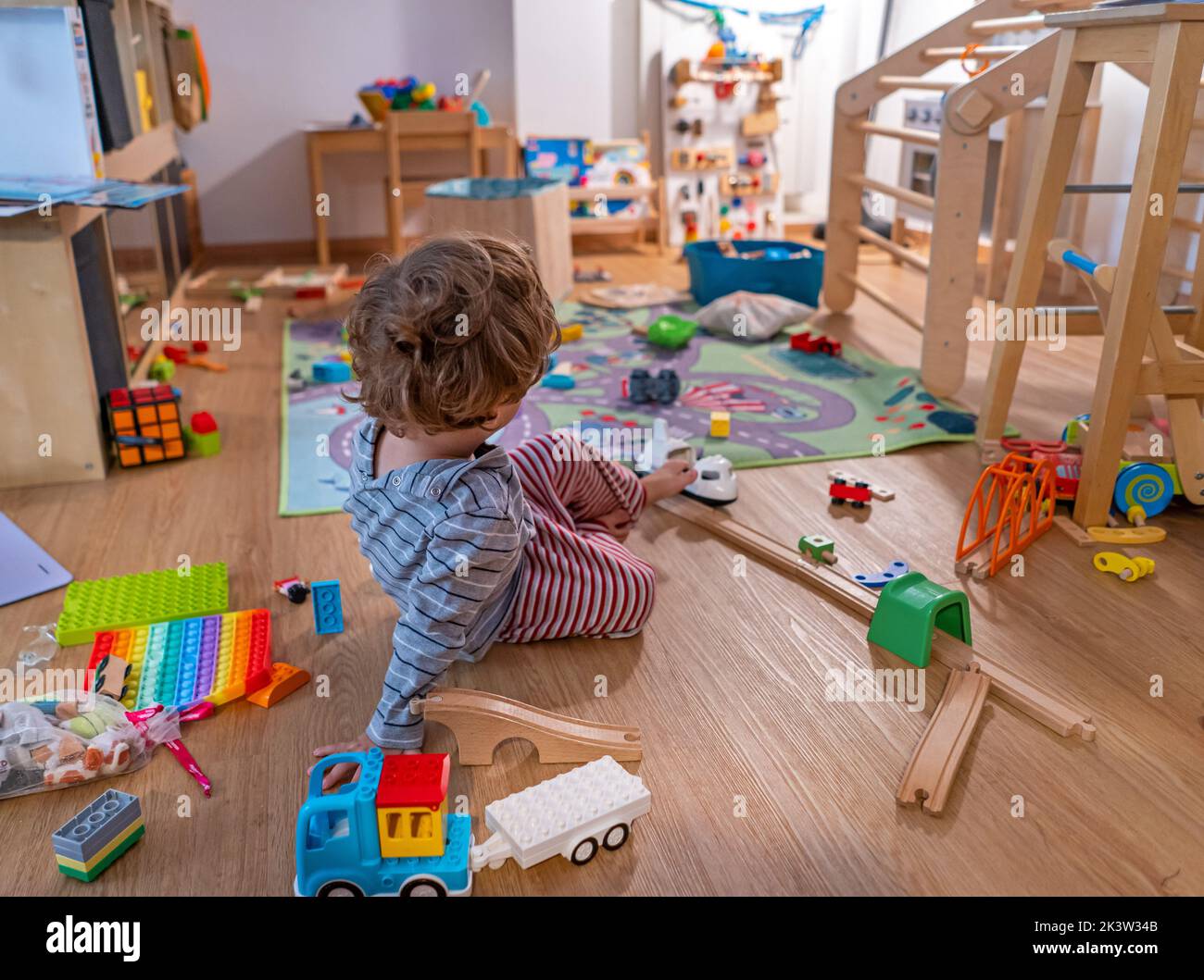 Baby Boy 2yo playing home with tos Stock Photo