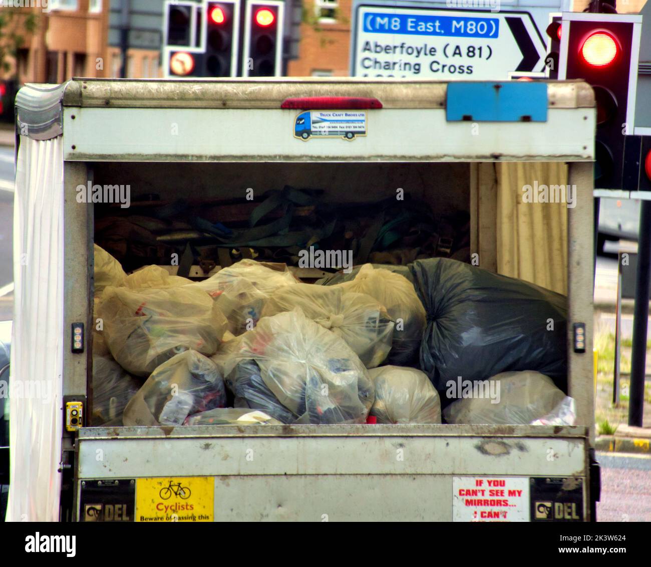 clothes for recycling in bags in back of a lorry Glasgow, Scotland, UK