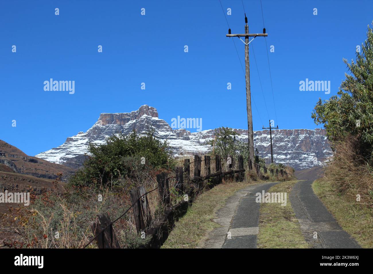 Winding path through the snow-capped mountains of the Drakensberg, South Africa Stock Photo