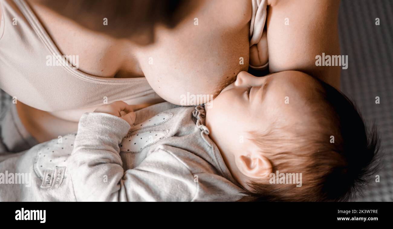 Mom mummy young mother with little baby daughter. Breast feeding. Mum feeding child with breast milk.Newborn cute happy girl smiling in woman hands Stock Photo Alamy