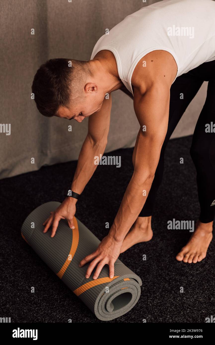 A young athlete spreads out a yoga mat. Top view Stock Photo Alamy