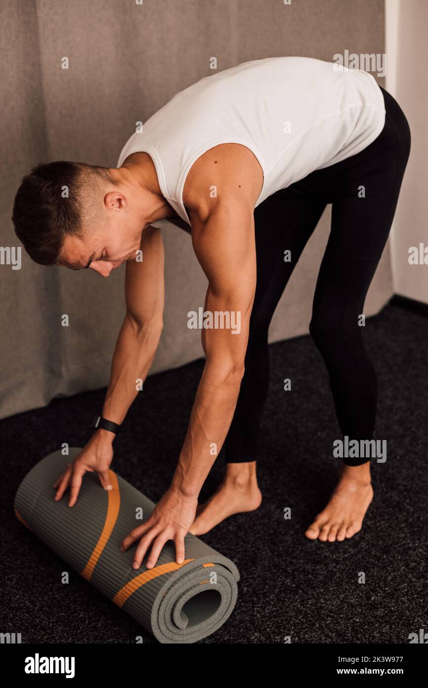 A young athlete spreads out a yoga mat. Top view Stock Photo Alamy