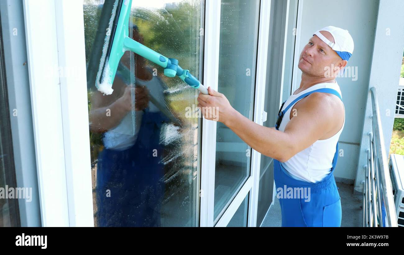 Premium Photo  Man washing and cleaning window at home housework