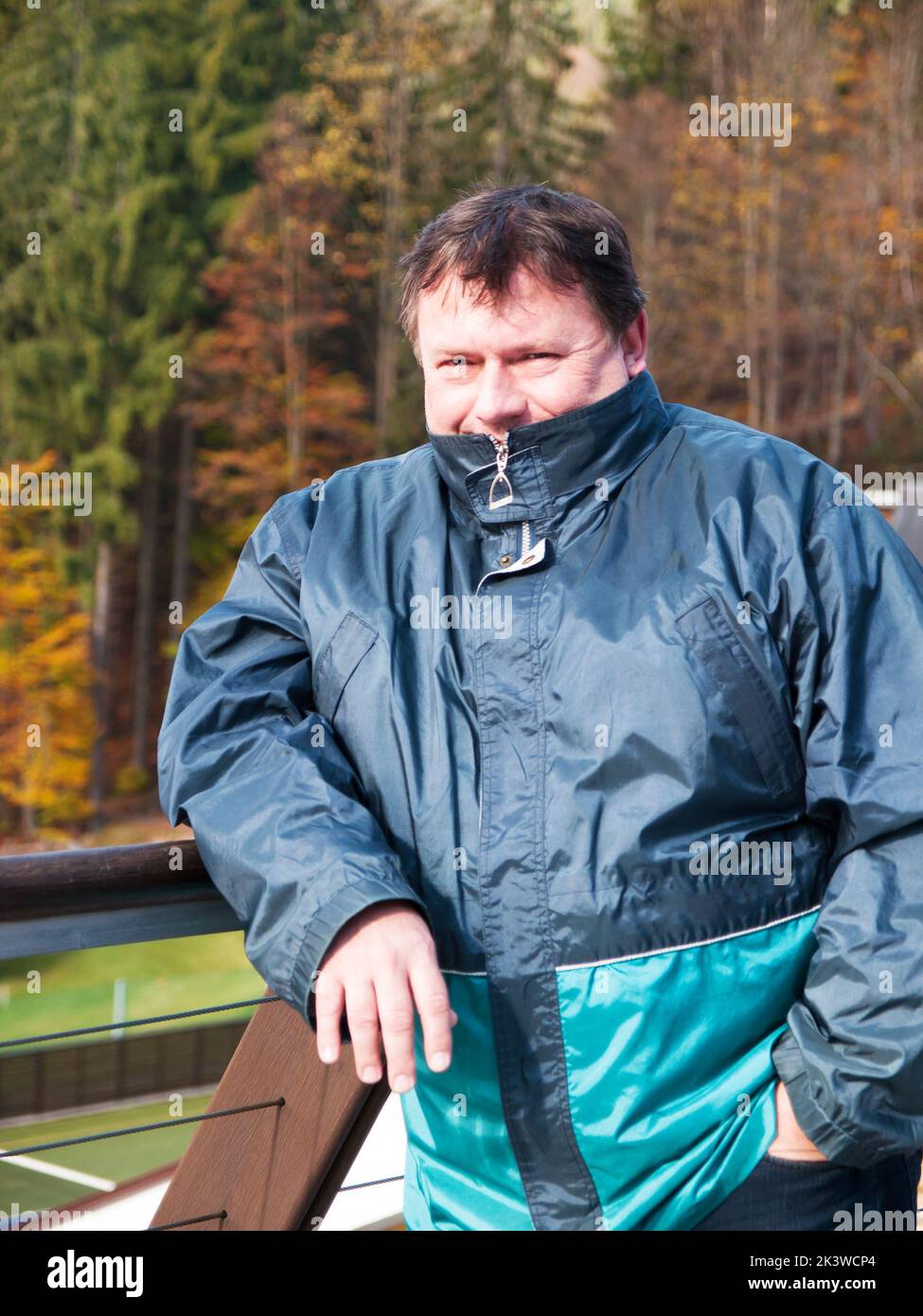 Portrait of mature man in jacket on teracce in autumn Stock Photo