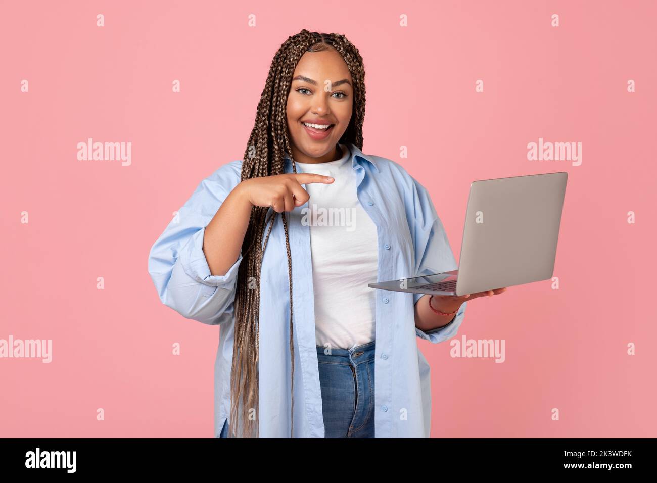 African American Woman Using Laptop Pointing At Computer, Pink ...