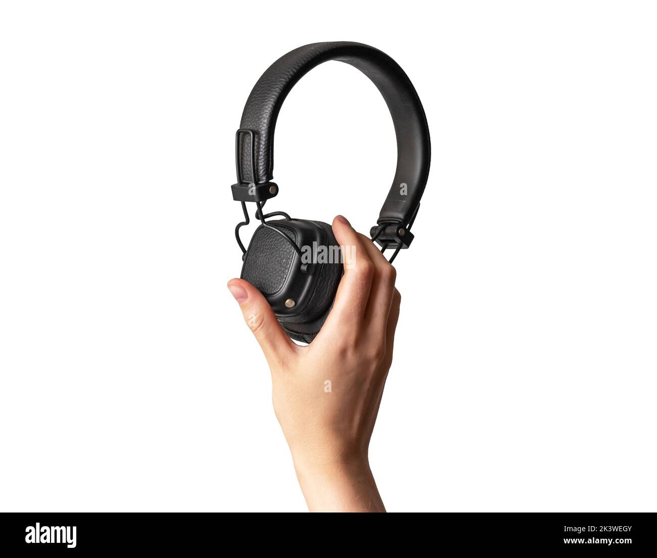Black headphones in hand isolated on white. High quality photo Stock Photo