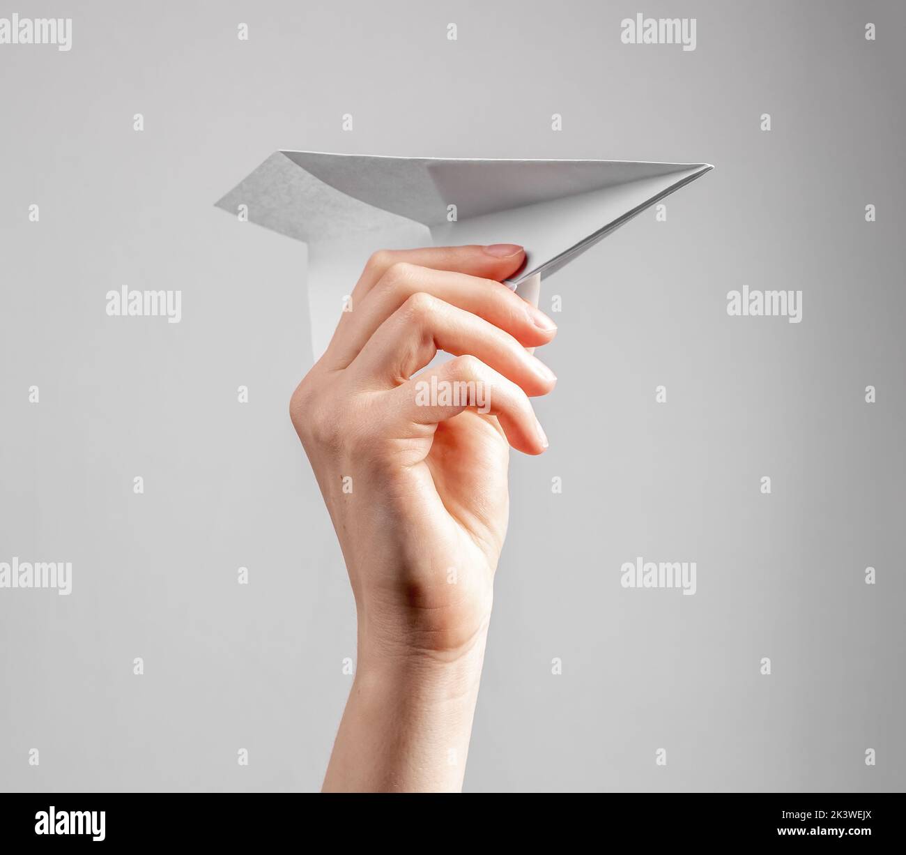 Paper plane toy in hand close up. High quality photo Stock Photo