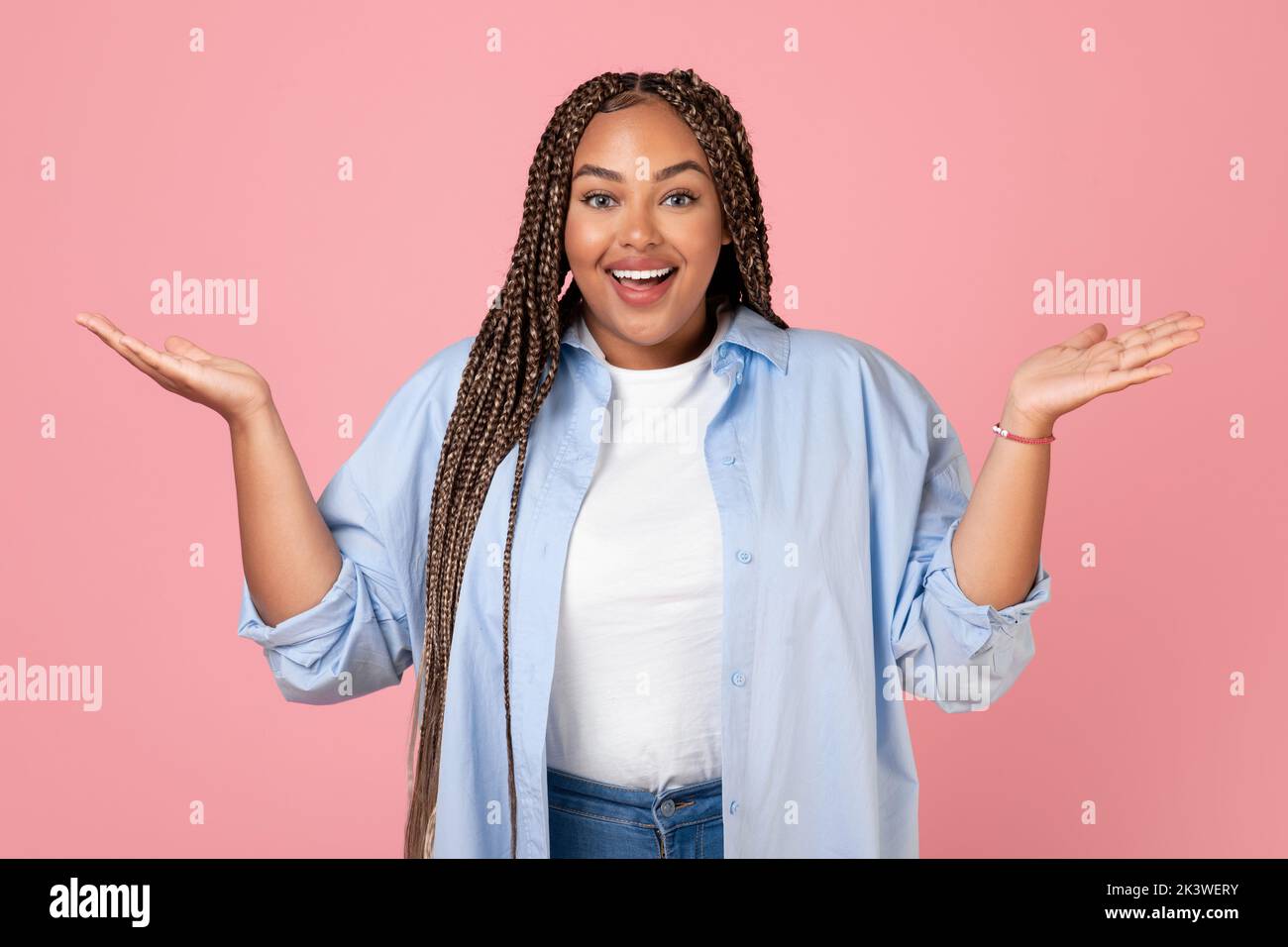 Excited African American Obese Lady Shrugging Shoulders On Pink Background Stock Photo