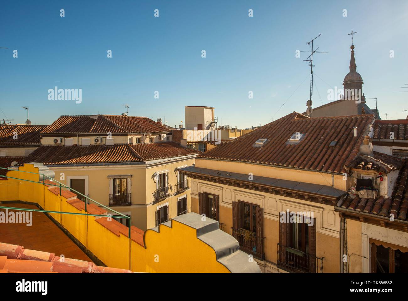 Clay roofs and church domes on a day with clear skies in Madrid Stock Photo