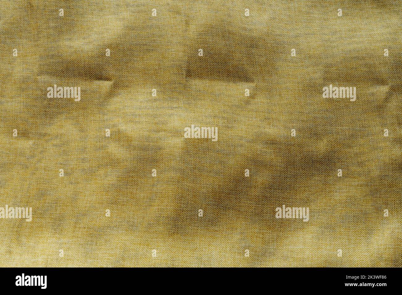Yellow fabric background with visible fabric and some wrinkles Stock