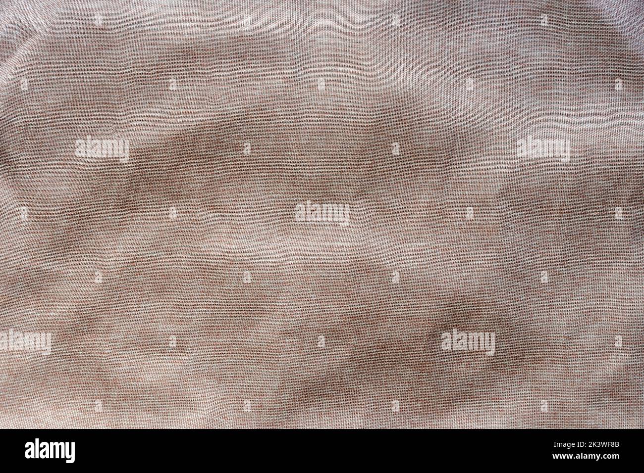 Light brown fabric background with visible pattern and some wrinkles Stock Photo