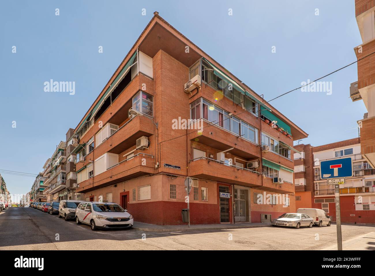 Facades of urban houses in the middle of the street with clear skies Stock Photo