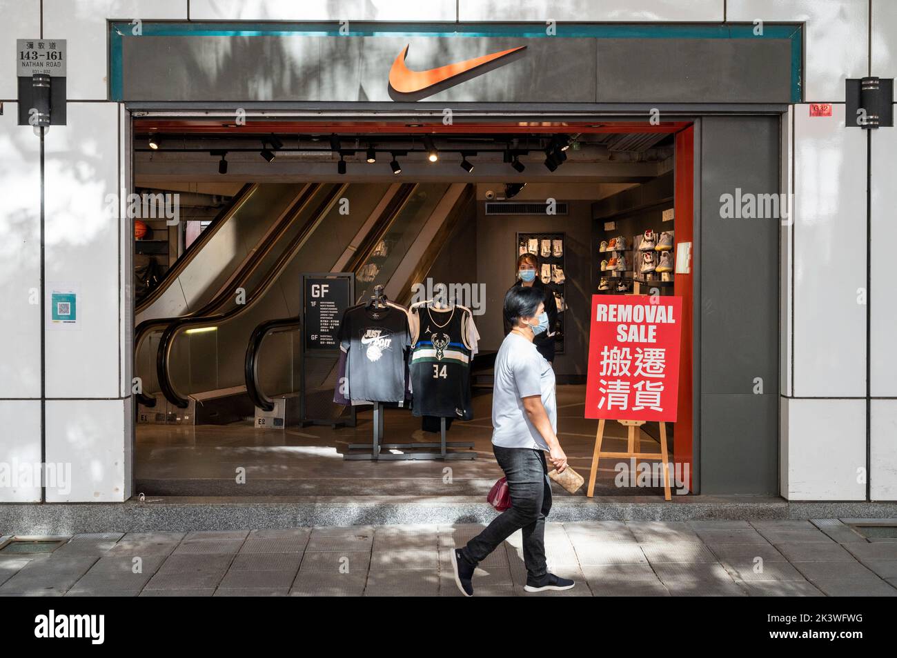 A pedestrian walks past a Nike store in Shanghai China 16 September 2011. Nike published its financial report for the fourth quarter ended May 31 Stock Photo Alamy