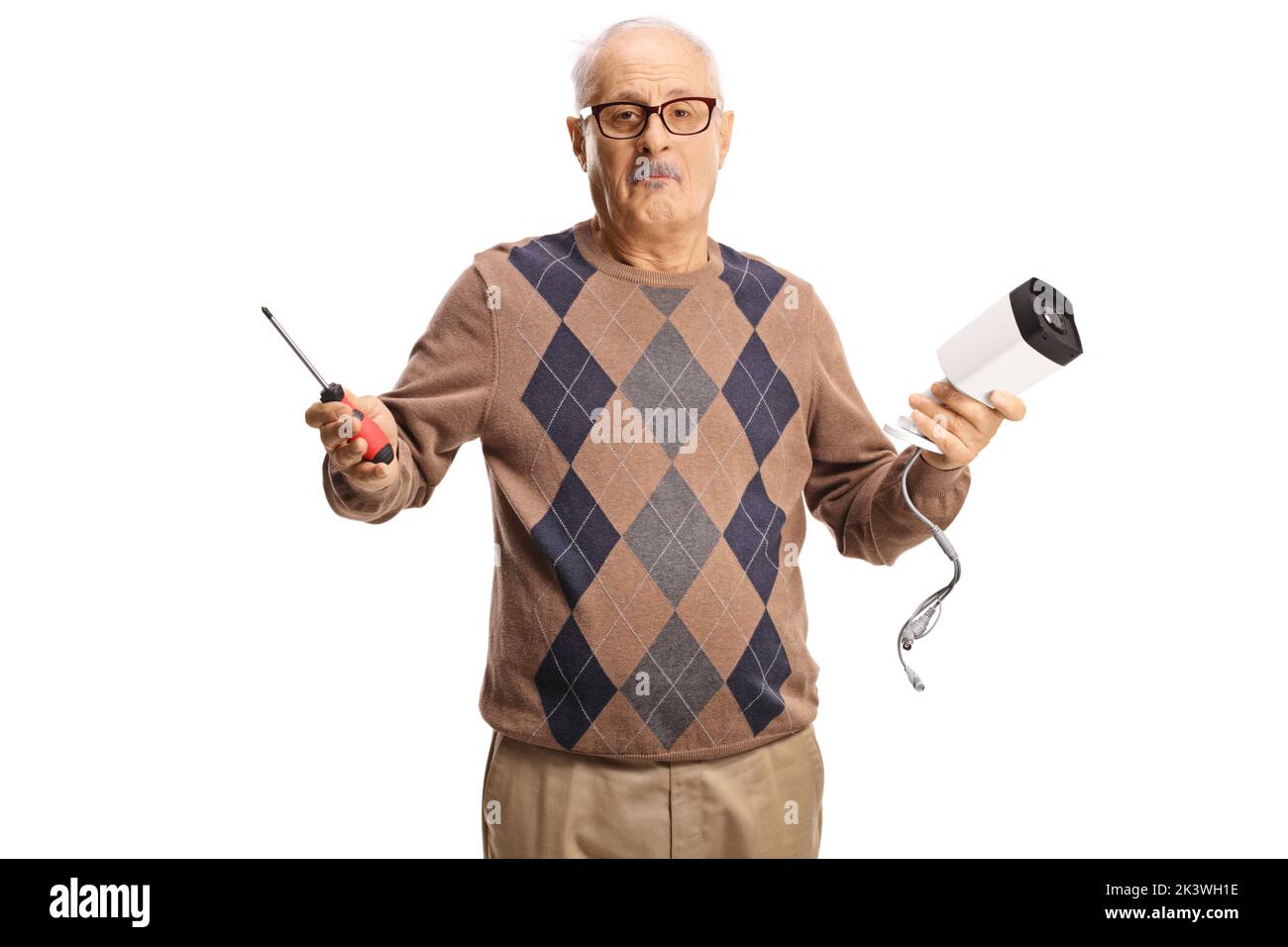 Confused mature man holding a security camera and a screwdriver isolated on white background Stock Photo