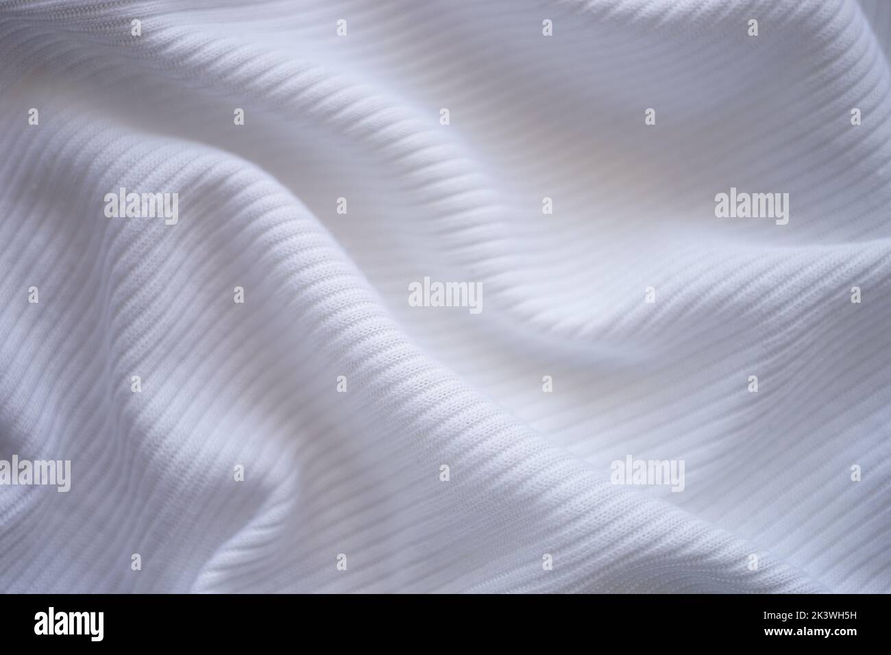 wrinkled white jersey, soft fabric background. Stock Photo
