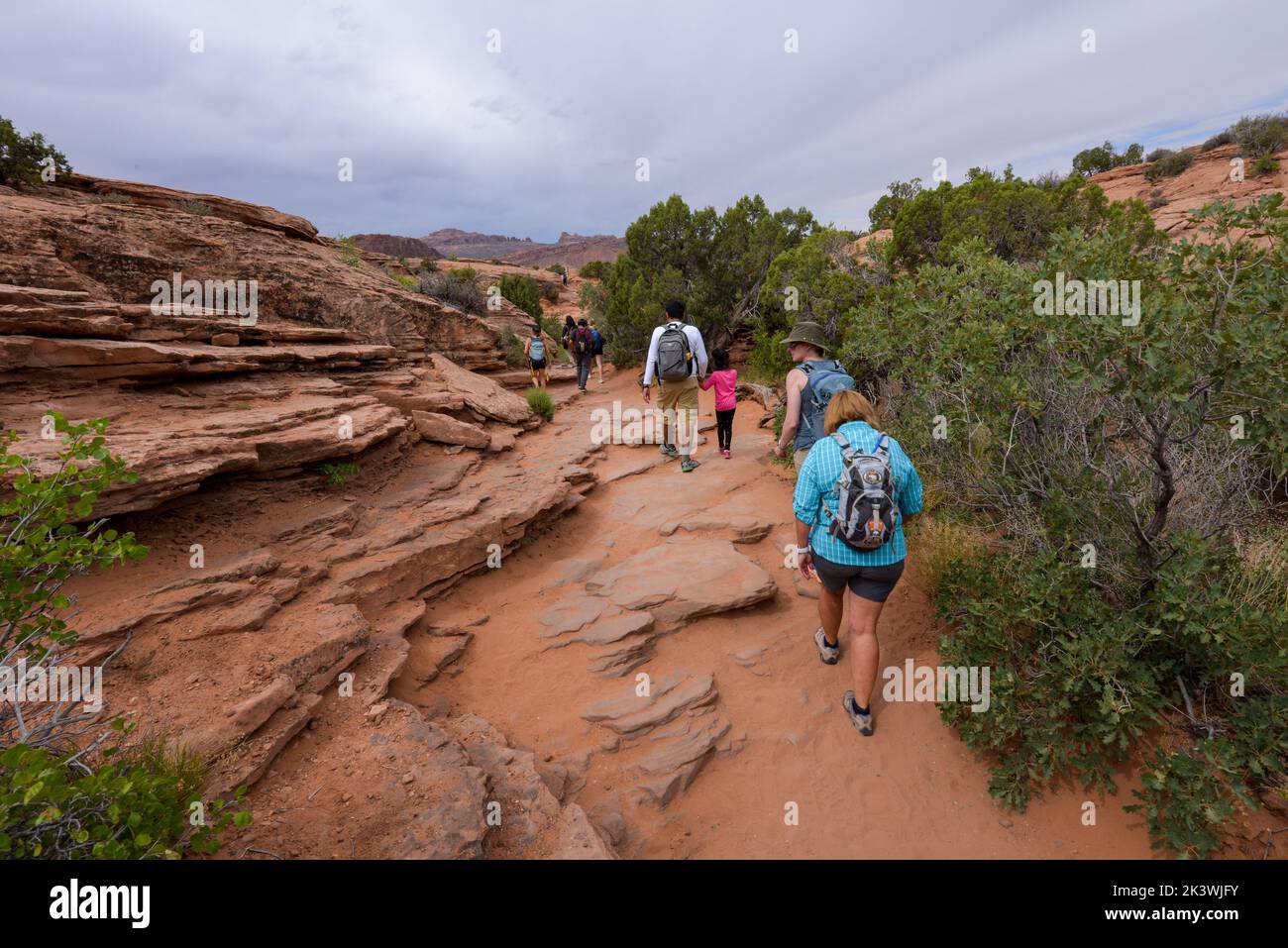 Families enjoying one of the many trails in Arches National Park in Utah USA Stock Photo