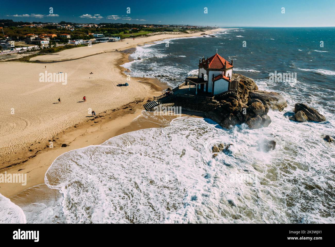 Aerial views of Senhor da Pedra Church, in the middle of the beach and ocean at Miramar, Portugal Stock Photo