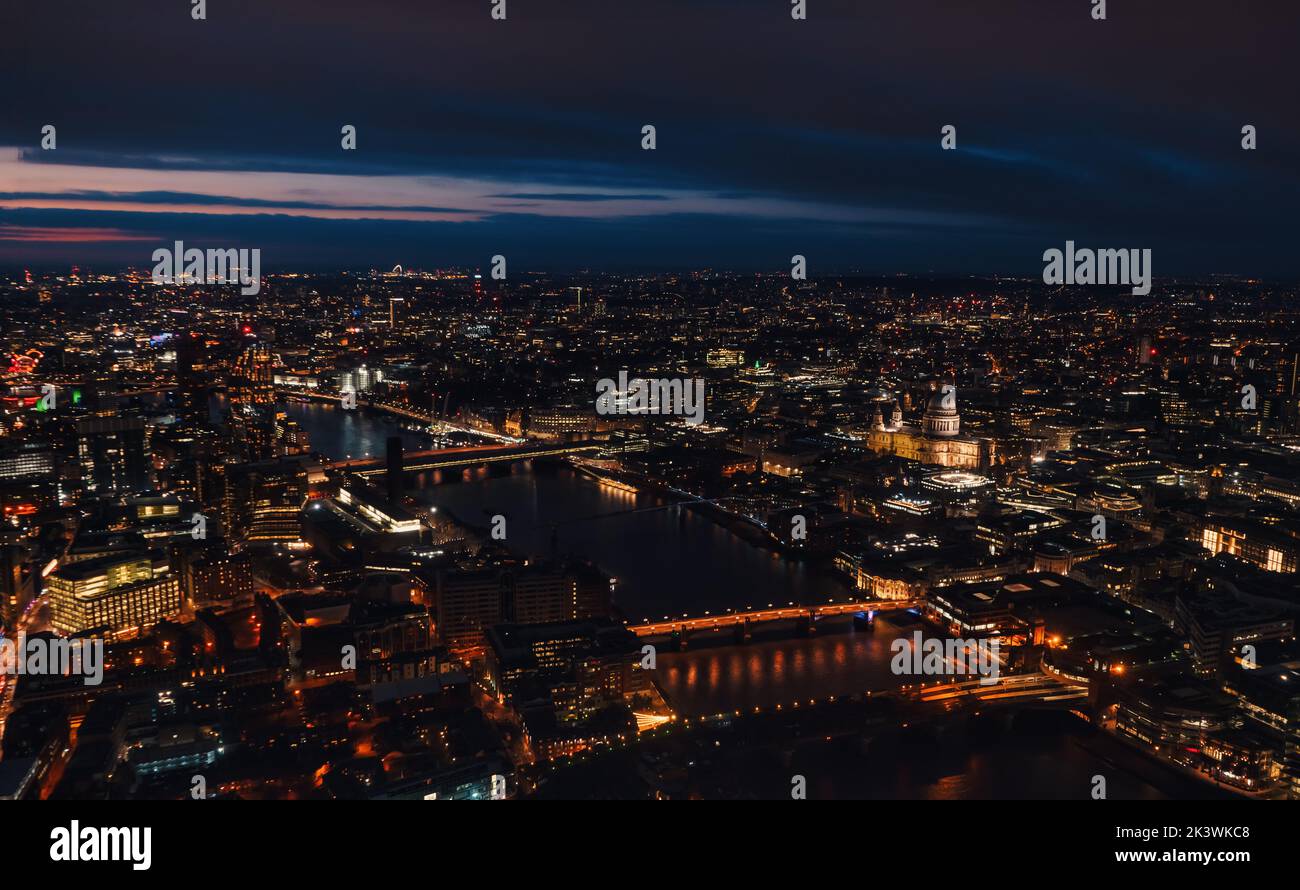 Aerial view of north east part of London, in evening. St Pauls Cathedral visible over river Thames Stock Photo
