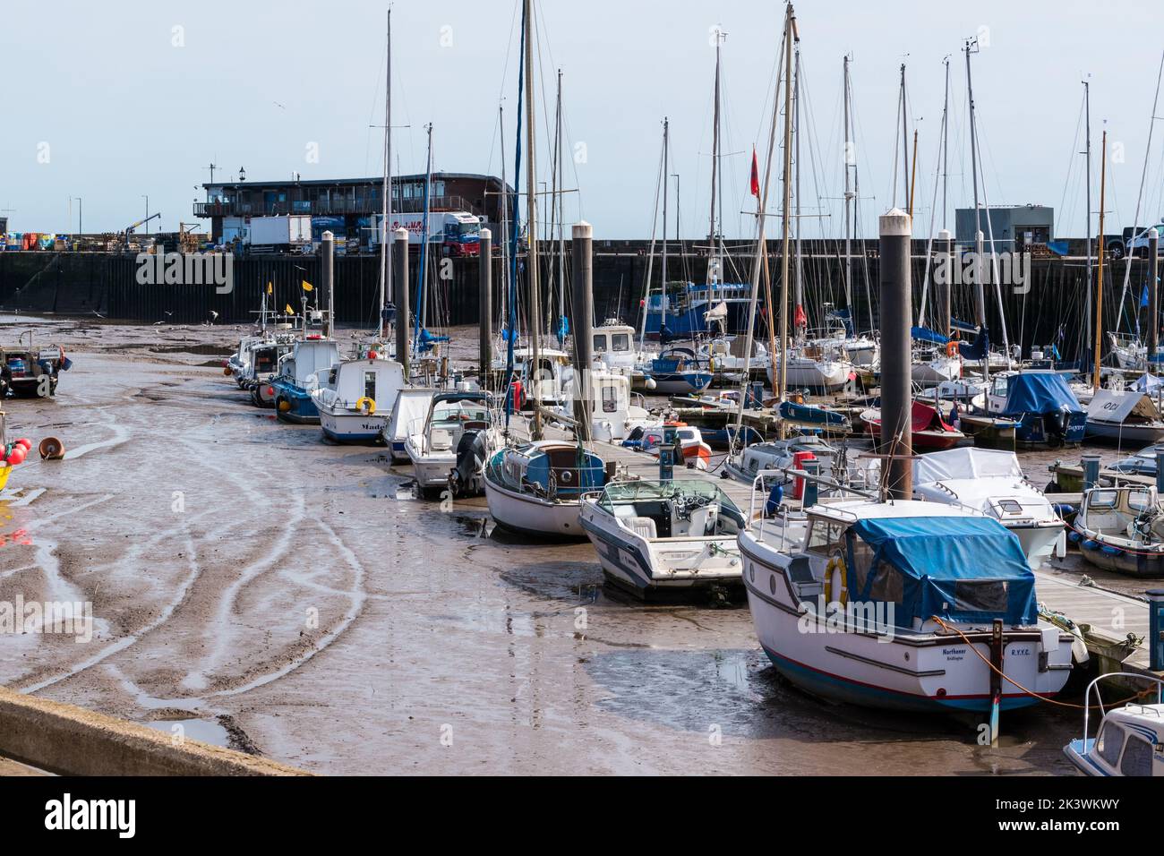 The harbour side in the Yorkshire seaside town of Bridlington, East Yorkshire with lots of small boats moored in the dock. Stock Photo