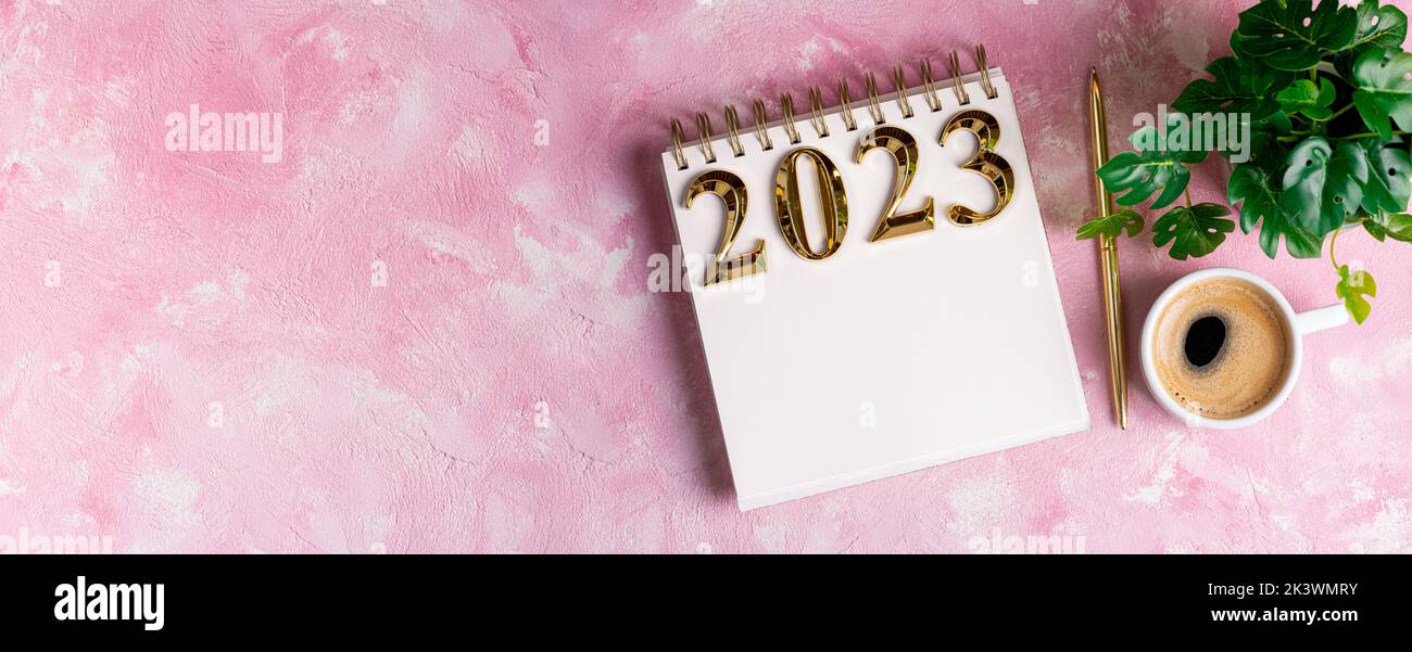 New year resolutions 2023 on desk. 2023 resolutions list with notebook, coffee cup on table. Goals, resolutions, plan, action, checklist concept. New Stock Photo