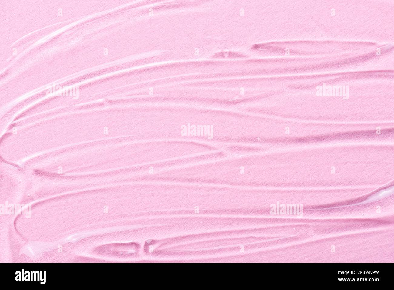 Liquid gel cosmetic texture on pink. Gel or sanitizer on pink background. Pattern of transparent gel for face cleansing. Moisturizing cosmetic beauty Stock Photo