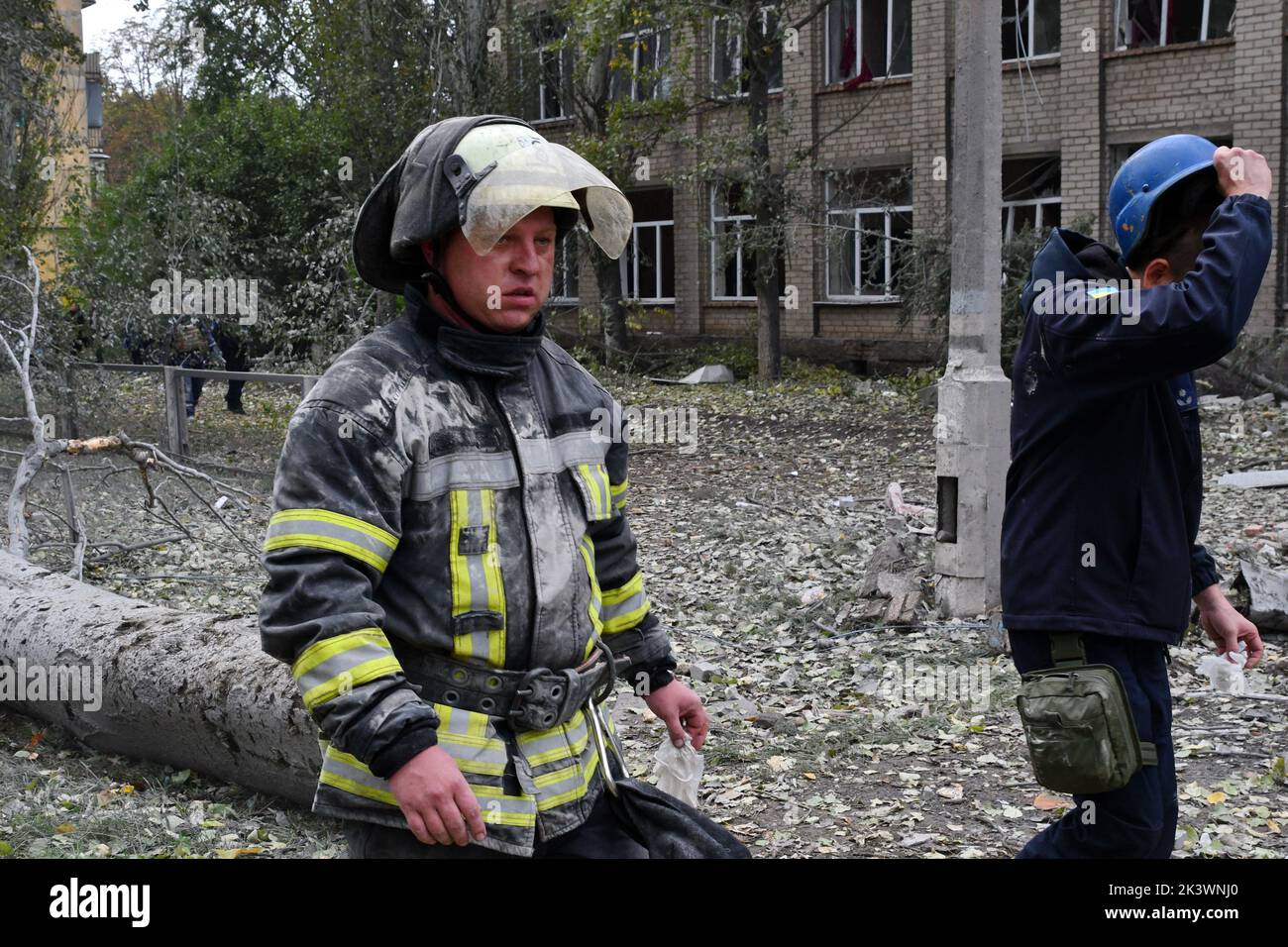 Rescuers are seen after they found a body of a school worker under the debris following a Russian attack that heavily damaged a high school in Mykolaivka. Dmitry Peskov, press secretary of the Russian President, has stated that Russia will continue the war even after sham referendums are conducted, and it will aim to occupy the entire territory of Donetsk Oblast. Stock Photo