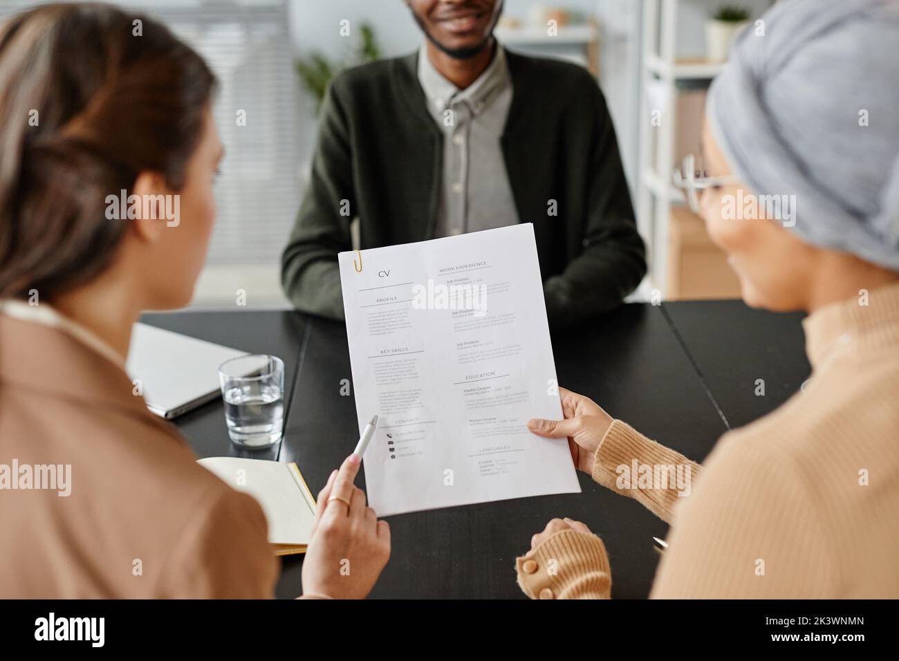 Back view closeup of two female HR holding CV of candidate at job interview Stock Photo