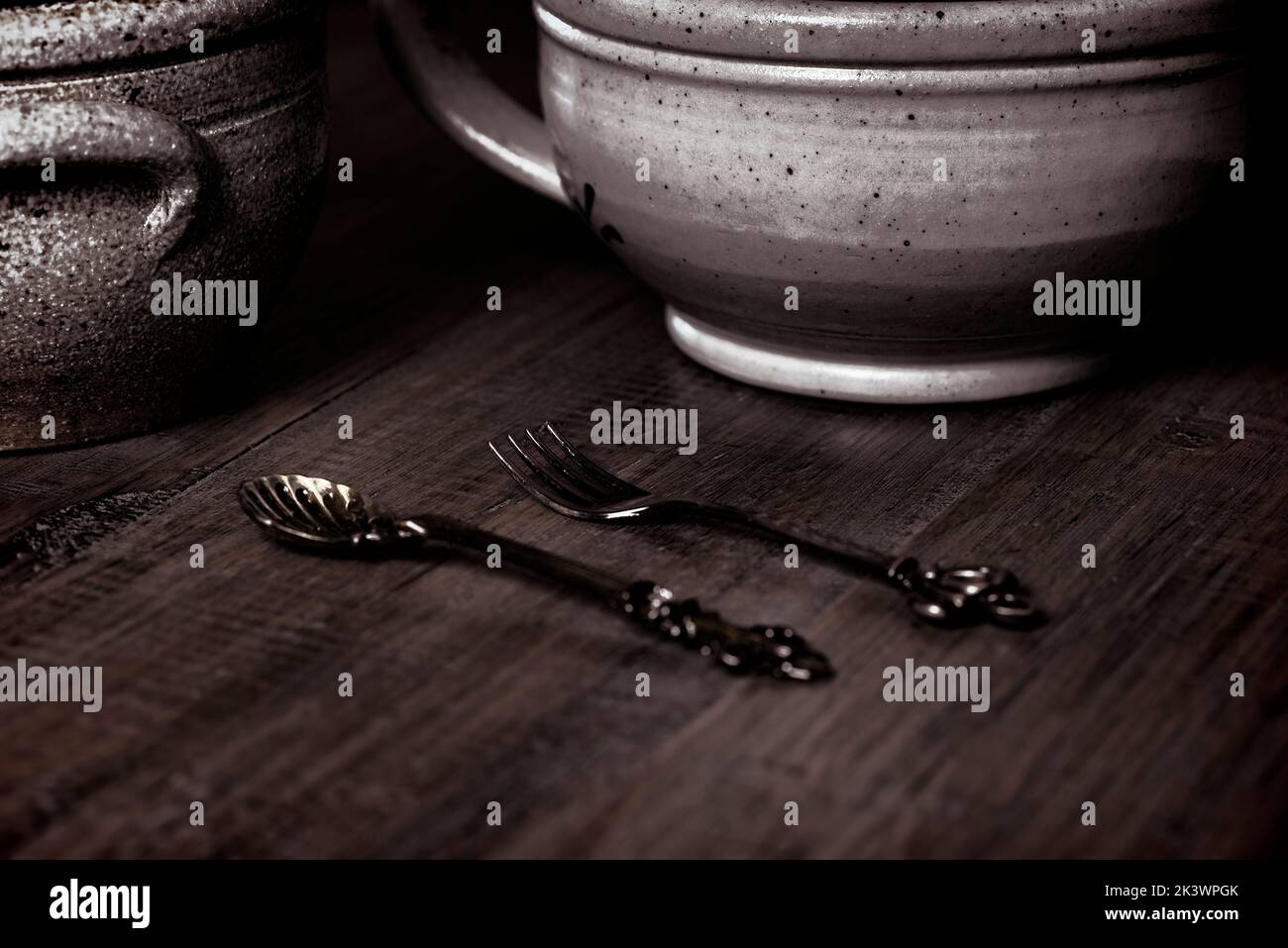 Antique presentation of vintage pottery and utensils, displayed on wooden surface. Stock Photo