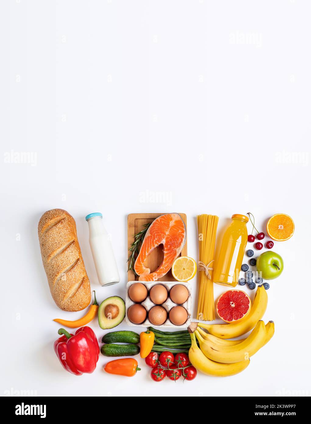 Healthy food background. Healthy food in shape of shopping basket - fish, pasta, vegetables and fruits on white table. Shopping food supermarket conce Stock Photo