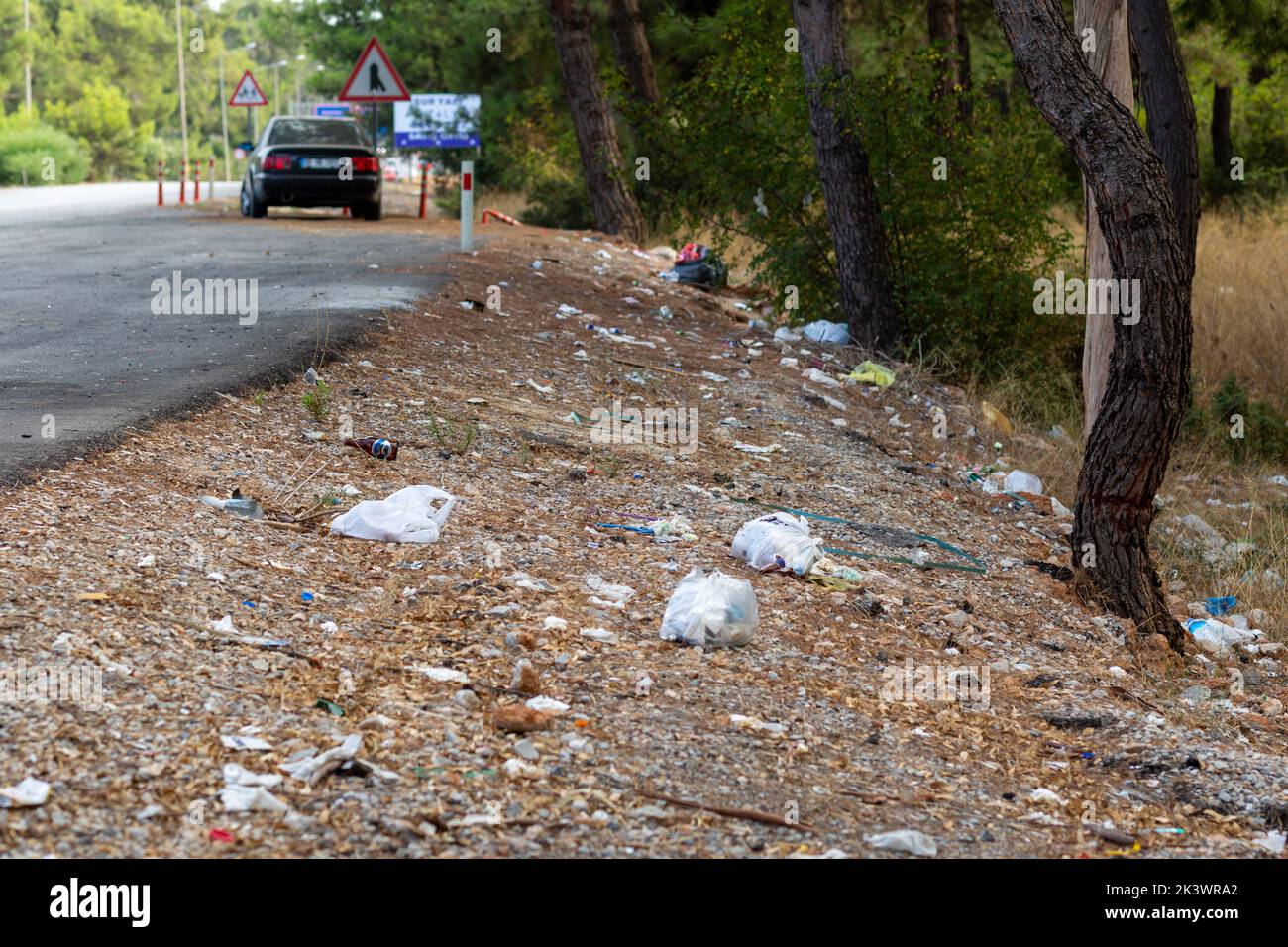 Garbage thrown on the side of the highway. Stock Photo