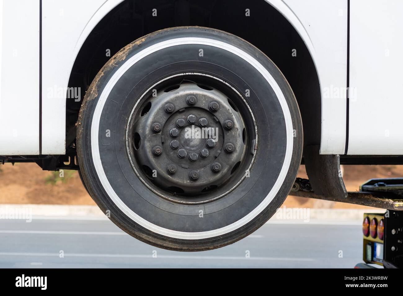 Bus wheel and lug nuts. Black wheel. Stock Photo